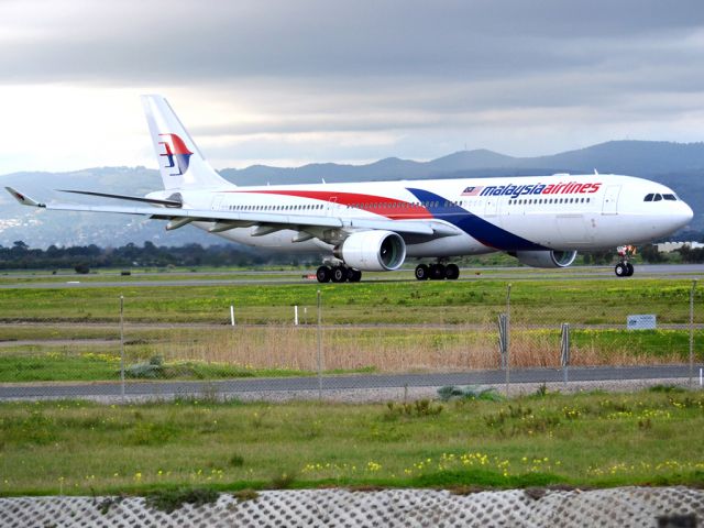 Airbus A330-300 (9M-MTC) - On taxi-way heading for take off on runway 05, for flight home to Kuala Lumpur, just before the arrival of a rain storm. Thursday 12th July 2012.