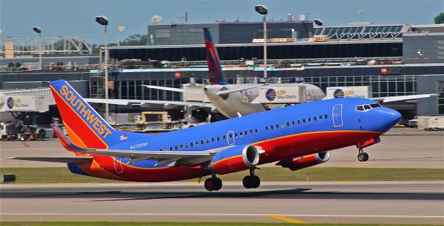 BOEING 737-300 (N372SW) - Southwest departs runway 12R.  A delta A330 is seen in the background, preparing for her departure to EHAM.