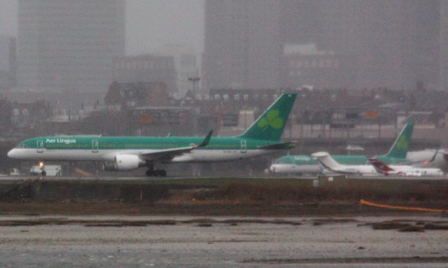 Boeing 757-200 (EI-LBS) - This Aer Lingus B752 preparing to depart BOS for JFK after diverting due to weather is lined up in heavy rain and wind. 