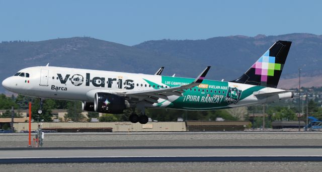 Airbus A320neo (N528VL) - VOI's Airbus (N528VL) with the special soccer livery and named "Barca" (for the FC Barcelona team) is just about to complete a flight from Guadalajara and touch down on 17R.