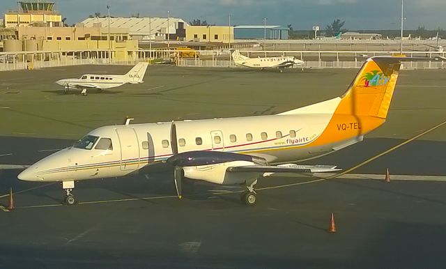 VQ-TEL — - 31-8-14 Air Turks and Cacos Embraer 120 on stand in the fading late evening sunlight at Nassau,Bahamas. The old control tower in the background is perched above a 1940s/50s stlye period terminal building. The newer concrete control tower is on the far side of the airfield.br /Nassau is a great location for spotting. Due to its location there are many visitors from the smaller airlines such as Air T&C . A great sight,snapped with my Nokia cellphone very quickly on my way to the gate for my journey home to LHR on board a BA 767, at the time of uploading on 19-6-2015 only 1 other photo of VQ-TEL exists in the FA photo database.