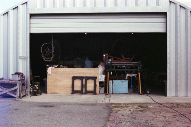 N887XP — - Tom Reilly working late one evening around 2016 in the XP-82 original restoration hanger. Look closely to see the covered canopies. Photo shot prior to mounting outboard wing sections, propellers, etc.35mm.