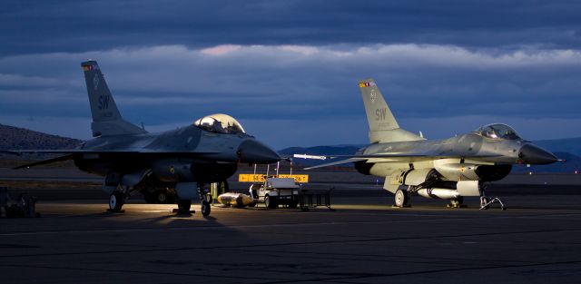 Lockheed F-16 Fighting Falcon (91-0376) - Two Air Combat Command East Viper F-16 Demonstration Team warbirds (91-0398 on the left and 91-0376) sit on the ramp at Reno Stead Airport (KRTS) in the twilight.  The ACC East aircraft arrived from Shaw AFB, Sumter, S.C., and they are in northern Nevada to fly demo performances during the National Championship Air Races.
