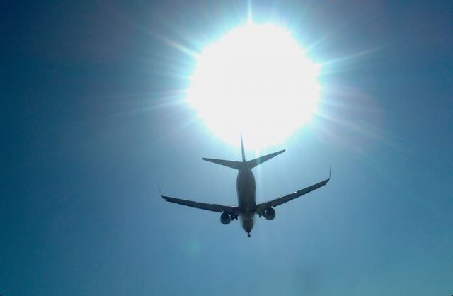 Boeing 737-700 — - I Was waiting this moment , at runway 25l threshold, the sun is above the plane eclipses , i am under them