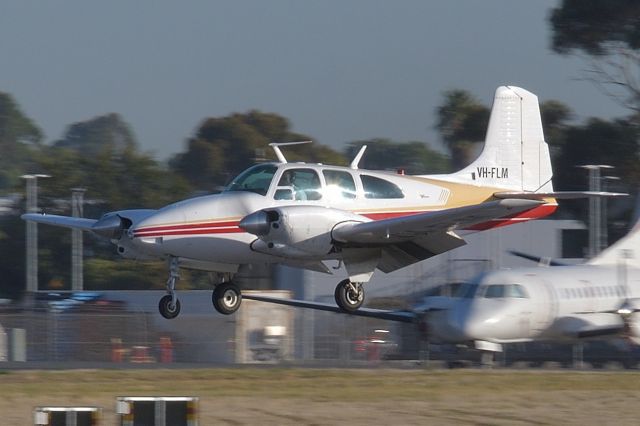 Beechcraft Travel Air (VH-FLM) - Feb 6, 2020. Landing on runway 23. 1966 vintage and still going strong. This shot was near my lens limit and was heavily cropped so unfortunately is a little less quality than preferred.