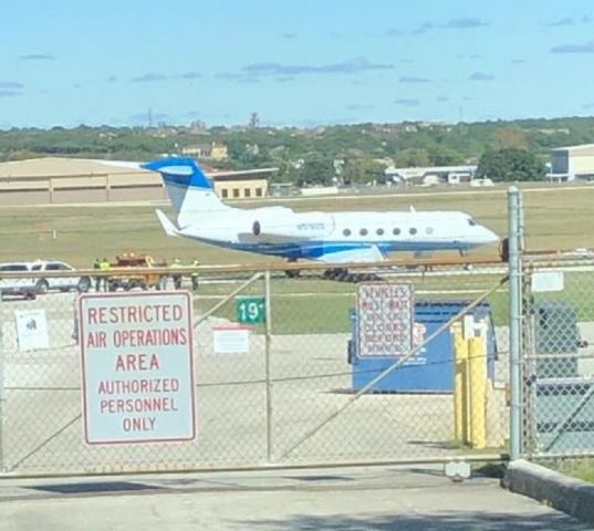 Gulfstream Aerospace Gulfstream IV (N518GS) - Right main stuck in the mud on taxi way, pilot misjudged turn. Stuck most of the day @ KSAT. George Strait's G450