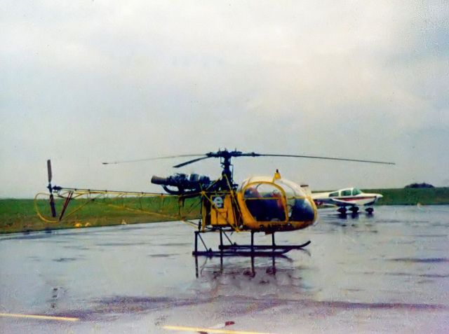 G-AWFY — - Aerospatiale SA.318C Alouette 2 Astazou (G-AWFY) On tarmac on a very rainy day at NCL. Private owner. (Photo Circa 1973-74) Apologies for the poor image.
