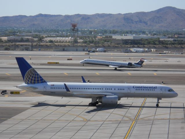 Boeing 757-200 (N18112) - Continental 757-200 at PHX with a Mesa CRJ-900 rotation behind