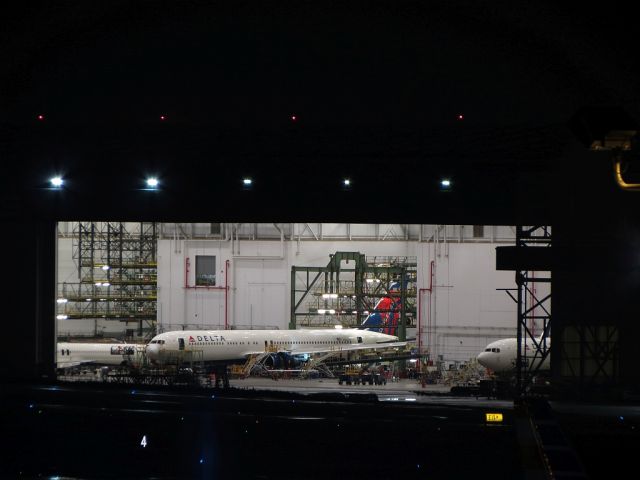 — — - N1402A being serviced at the Delta TOC