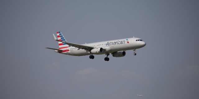 Airbus A321 (N994AN) - Couldnt quite read the tail number on the plane in the background.