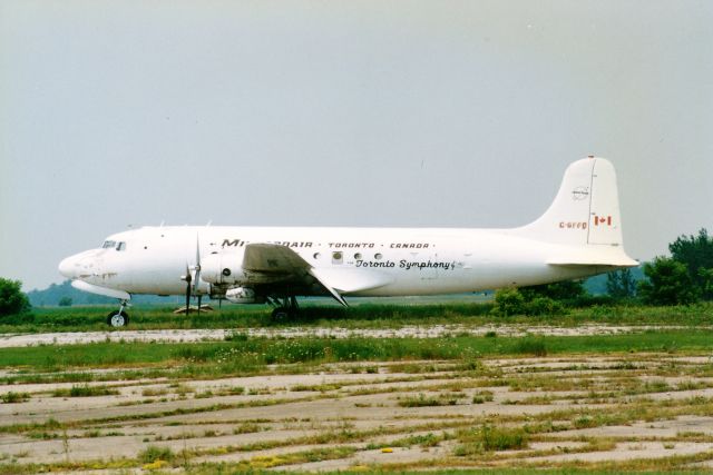 Douglas DC-6 (C-GFFD) - This is probably one of the rariest photos i have in my collection,this old beauty sitting out in the field at Brantford Airport,Brantford,Ontario,Canada,Taken back in the 1990s.