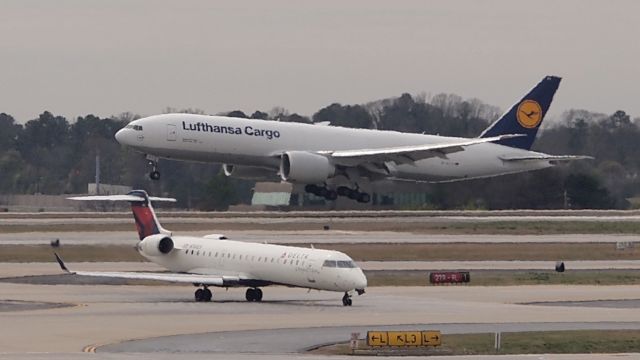 BOEING 777-200LR (D-ALFC) - I couldnt see what happened from where I was (coucourse A) but this bird went around right after this touchdown.  I also caught the 2nd (and successful) attempt which is posted here on flightaware.