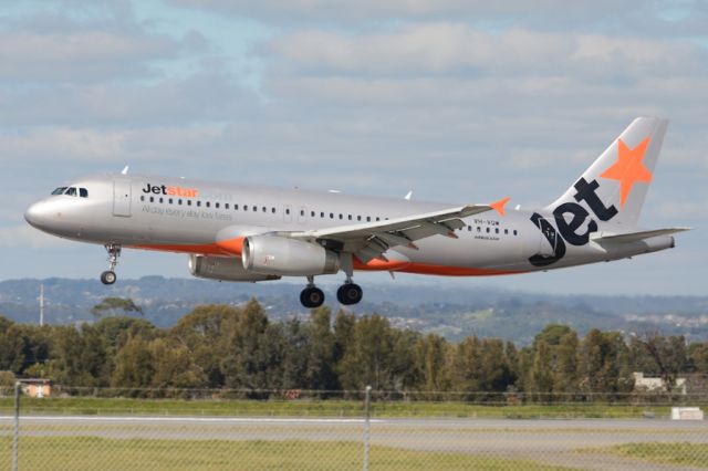 Airbus A320 (VH-VQW) - About to put down on runway 05. Thursday 7th August 2014