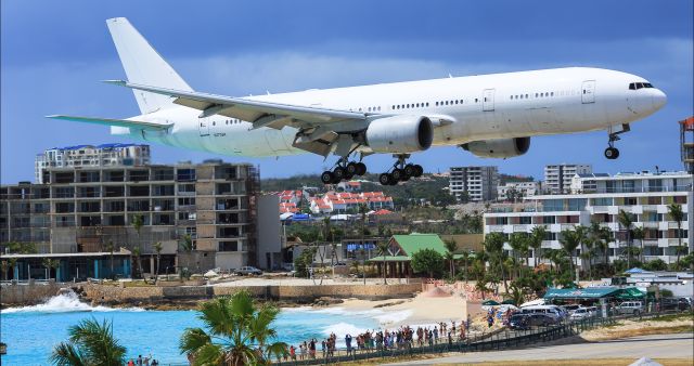 Boeing 777-200 (N777UK) - Private B777UK over the thresh hold maho beach St Maarten for landing.