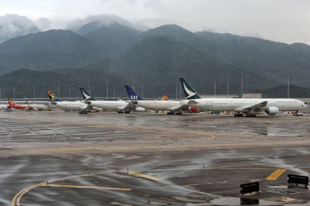 BOEING 777-300 (B-HNM) - 12th August, 2019: Line up of stranded wide bodies at Hong Kong's Chek Lap Kok International Airport minutes before pro-democracy protesters outside the terminal forced the airport to close. 