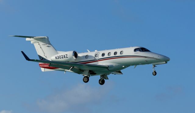 Embraer Phenom 300 (N302AZ) - N302AZ landing at St Maarten