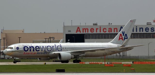 BOEING 767-300 (N395AN) - Flashback to 2013 ~~~br /AAL's N395AN*, wearing "One World" livery paint, taxies away from American's mx facility at O'Hare in this click taken nine years ago.br /* This Boeing heavy is no longer in American's fleet. It has been converted to cargo configuration and today it is dressed in Amazon's "Prime Air" scheme (operated by ATI) and has been reregistered as N499AZ. *