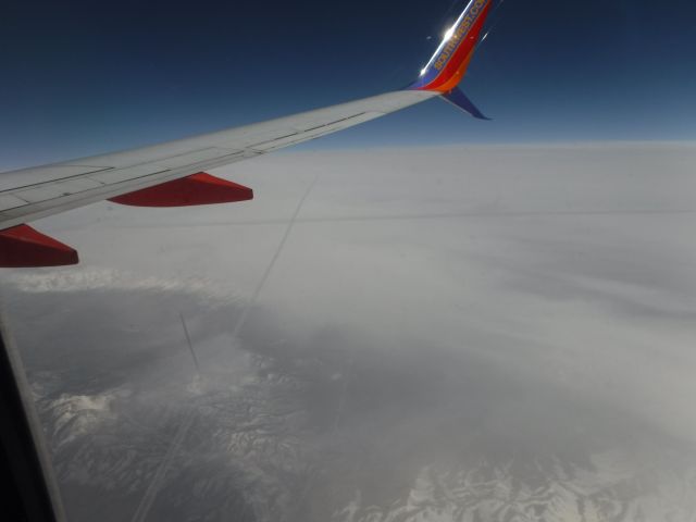 Boeing 737-700 — - Flying over a couple other con trails somewhere over southern Utah going into Northern Arizona on the way to Phoenix, Arizona