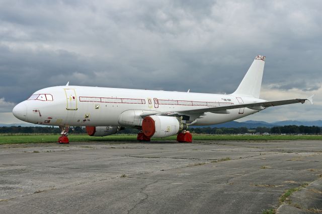 Airbus A320 (ES-SAU) - Stored at Ostrava Airport with temporary registration OE-IOP. Photo taken on September 18, 2021.