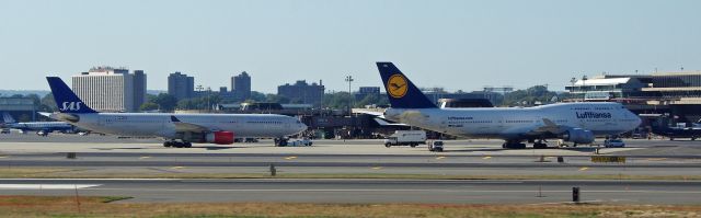 Boeing 747-400 (D-ABVC) - NEWARK, NEW JERSEY, USA-OCTOBER 09, 2011: Seen on the ground at Newark International Airport was this Lufthansa 747 and Scandinavian (SAS) Airlines jet.