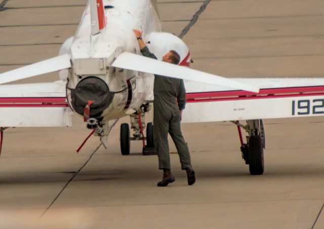 — — - PILOT CHECKING A MARINE TRAINER