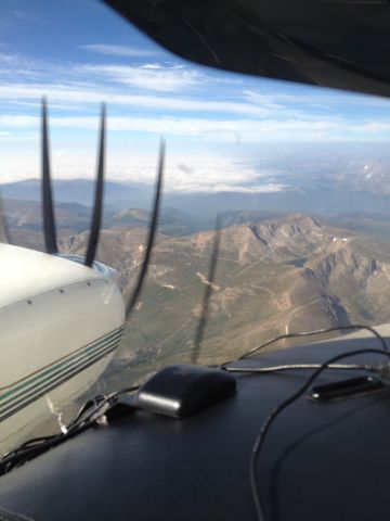 Beechcraft Duke (N500RS) - Over the Colorado Rocky Mountains,  Obscured down in the valley!