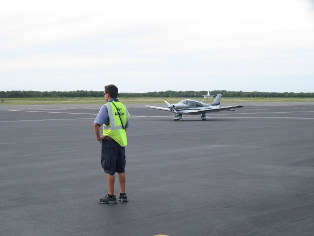 Piper Cherokee (N208GG) - AOPA Get Your Glass 2008 prized Archer II. Resting on the ramp of Marthas Vineyard Airport with MVY VOR in the background and a ramp attendant awaiting arrivals.