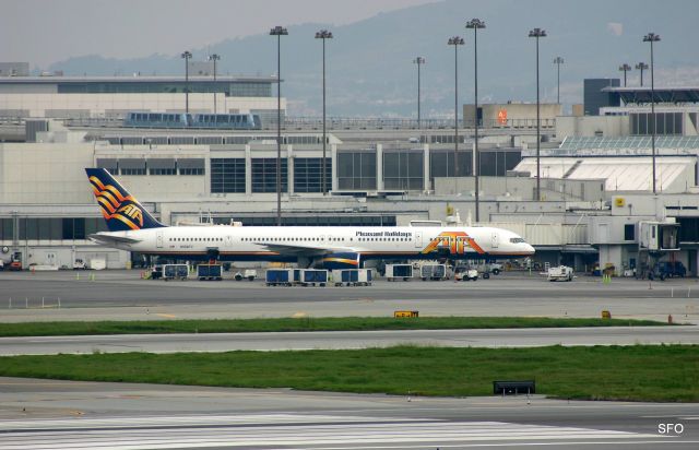 BOEING 757-300 (N558TZ) - KSFO - early AM flight to HNL being readied for the passengers. Im still unsure why so many airlines missed the boat and did not order any 757-300s,,,the perfect jet for heavy traffic corridors...Note Ben W up on the tram - hit full size for full flying pencil effect.