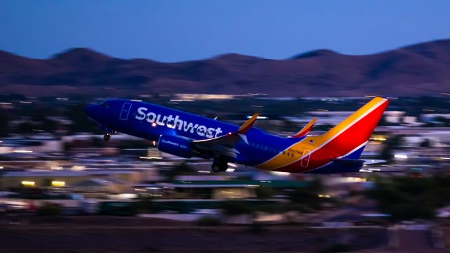 Boeing 737-700 (N857WN) - Southwest Airlines 737-700 taking off from PHX on 8/20/22. Taken with a Canon 850D and Rokinon 135mm f/2 manual focus lens.