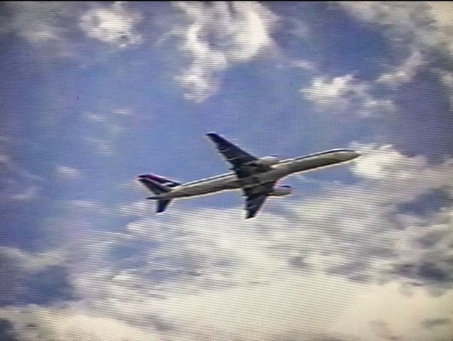 Boeing 757-200 — - Sorry for the poor quality.  Taken at ATL with a very old and basic digital camera somewhere around 2002/2003.  One of my earliest times plane spotting as a kid!  A Delta 757 wearing the Ron Allen livery!