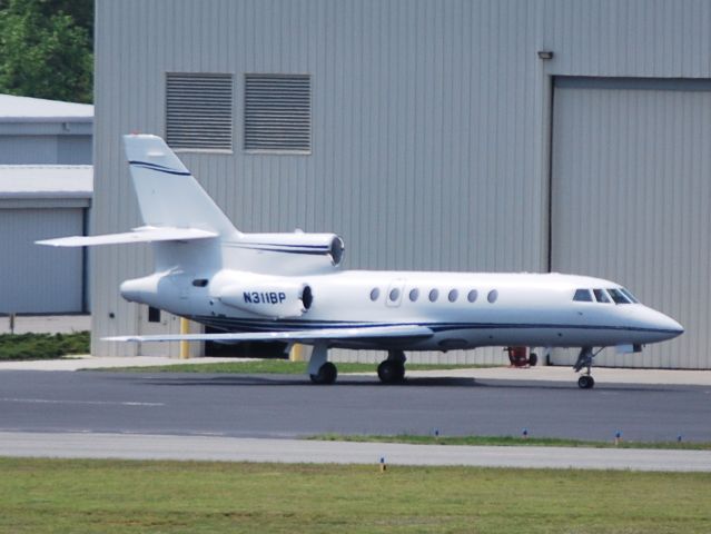 Dassault Falcon 50 (N311BP) - JET PLAID LLC (Brad Paisley) parked in front of the Hendrick Motorsports hangar at KJQF- 4/19/11