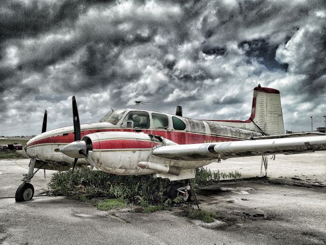 Beechcraft Travel Air (N102SF) - How many stories could this old T-Bone tell?  Rest in peace old bird... at Saipan Intl.