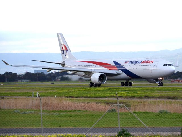 Airbus A330-300 (9M-MTC) - On taxi-way heading for take off on runway 05, for flight home to Kuala Lumpur, just before the arrival of a rain storm. Thursday 12th July 2012.