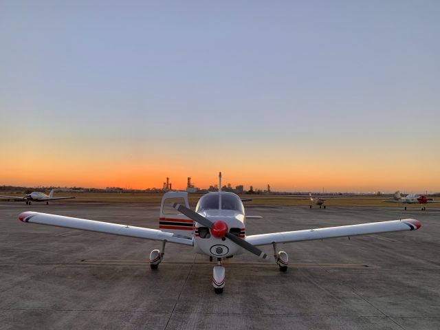 Piper Cherokee (N95044) - As the sun sets on another cool and clear winter day, pilot HH preflights for the quick trip back to KCXO.