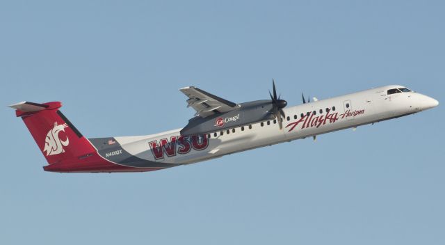 N401QX — - QXEs Washington State University-liveried Dash 8 climbs away from runway 16R during an afternoon departure from Reno on New Years Eve.