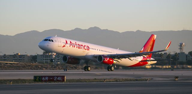 Airbus A321 (N692AV) - Early morning departure from runway 24R, Los Angeles, California. I know, the sign says 24L. That is because there are two parallel runways. The one this airplane is departing from is 24R.  8 November 2014