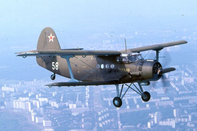 Antonov An-2 (ДОСААФ58) - August 1992, we had some flights from Khodynka Aerodrome (Ходынский аэродром), Moscow's first airport, and so I could made this picture of this Antonov AN-2 over Moscow. My plane was an Yakovlev Yak-18T. This Airport also known as Frunze Central Aerodrome is closed now, so it has none airport codebr /br /This Aircraft was driven by DOSAAF (Russian: ДОСААФ, = Добровольное Общество Содействия Армии, Авиации и Флоту), the Volunteer Society for Cooperation with the Army, Aviation, and Navy. A paramilitary sport organisation in the Soviet Union.br /br /Scan from my Kodachrome 64 slide