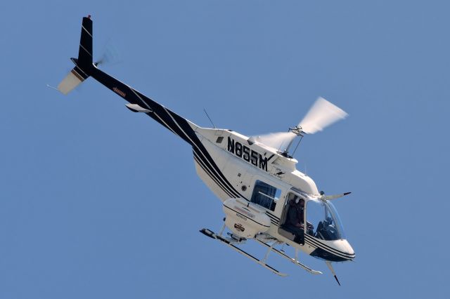 Bell JetRanger (N855M) - 5/19/2015. Ft Myers. Florida Mosquito Control Jet Ranger. The ship was dive bombing over our hotel not more than 100 feet from the roof. Shot through the room window on the fifth floor. 