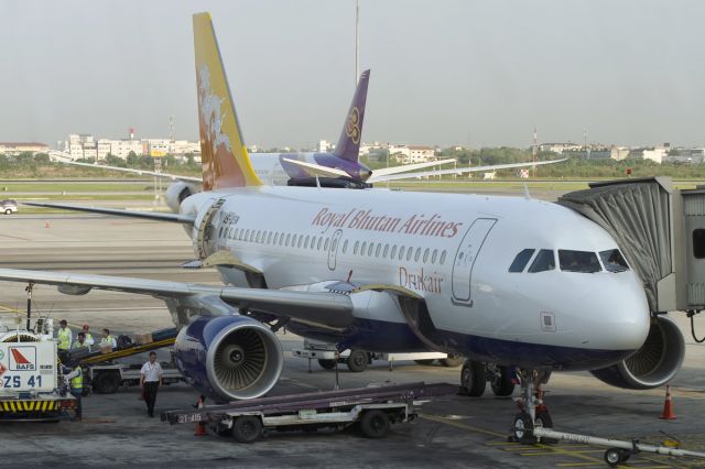 Airbus A319 (A5-JSW) - A5-JSW named after the father of the reigning monarch of Bhutan was delivered on the 15th of March, 2015. Seen here, the aircraft is being prepared to fly His Majesty the King and Her Majesty the Queen of Bhutan (returning from Singapores former PM Mr Li Kwan Yews funeral) and plebs like yours truly on this 15 day old Airbus A319 from Bangkok to Paro. 31st March, 2015