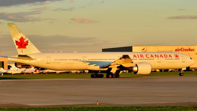 BOEING 777-300ER (C-FIVX) - Awaiting clearance on Rwy 24L for the daily evening service to London Heathrow.