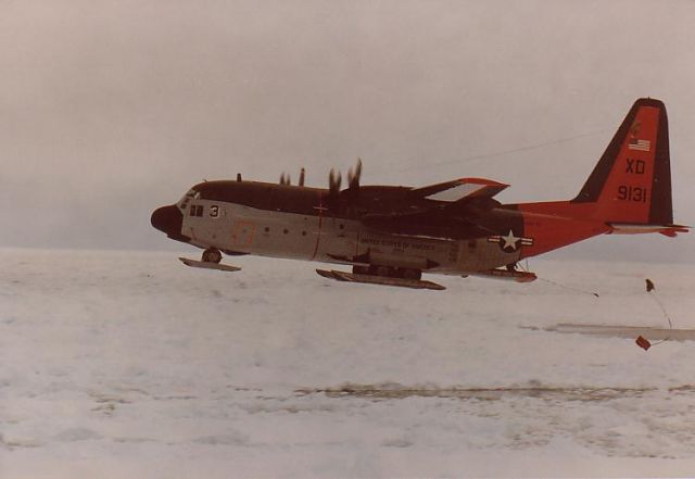 — — - A VXE-6 LC-130 air dropping a helicopter repair part in Antarctica during Operation Deep Freeze.