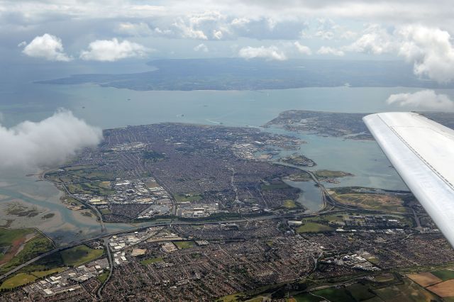 — — - Portsmouth UK, Isle of Wight other side of Solent (Strait) flight just dep Southampton for Cannes, France - Falcon 50