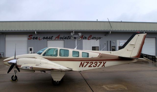 Beechcraft Baron (58) (N7237X) - Waiting to load cargo. One of RELIANT AIRs pristine Barons.