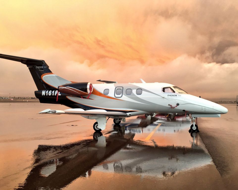 Embraer Phenom 100 (N161PL) - Phenom 100 on the very rare wet ramp in North Las Vegas under ominous skies.