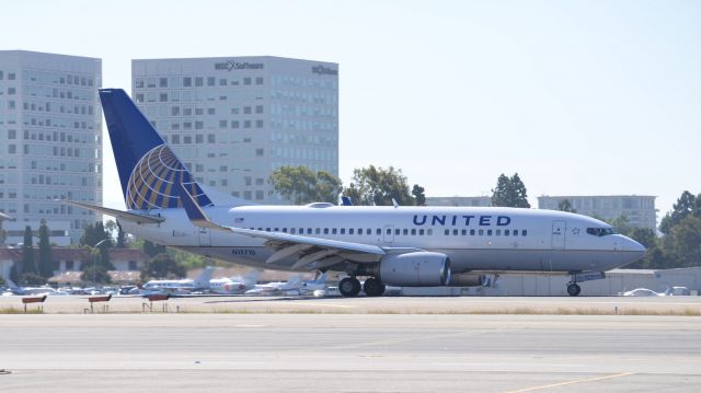 Boeing 737-700 (N15710) - N15710 seen here arriving at JWA from Denver. The spoilers have already been retracted as this 737 is about to turn off the runway onto taxiway"echo".