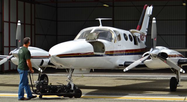 Cessna 421 (N200WM) - Pushing back a local Cessna 421 into its hangar.