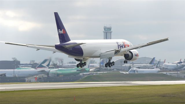 Boeing 777-200 (N885FD) - BOE056 nears touchdown on runway 16R. 10/25/11.