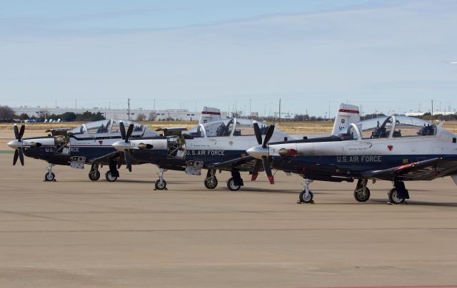 Raytheon Texan 2 (05-6207) - The T-6II in the foreground is based at Randolph AFB, TX while the 2 in the back ground are based at Vance AFB on the ramp at Alliance for gas and gos. (Please view in "full" for highest image quality)