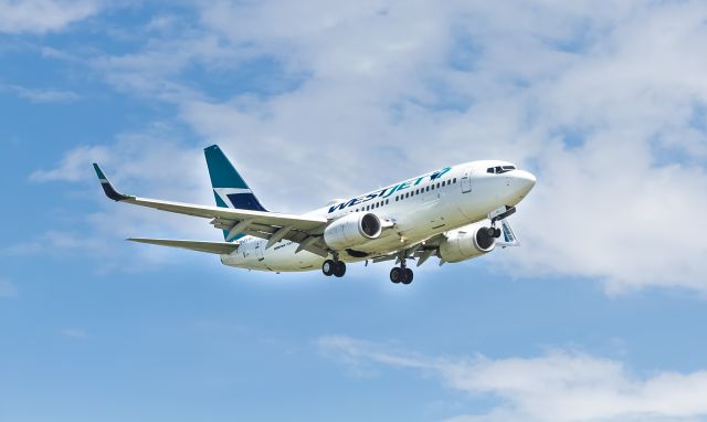 Boeing 737-700 (C-FXWJ) - >>PleaseSelect FULL for proper resolution<<br /On final from St. John's (YYT) to 24R at YYZ on Tuesday, July 16, 2019