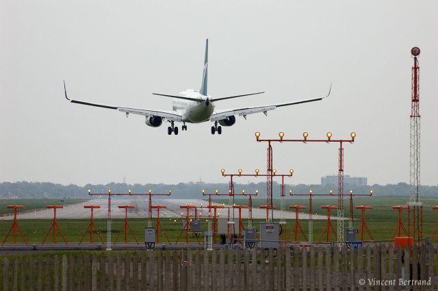 Boeing 737-700 — - Seconds before touchdown, runway 24R